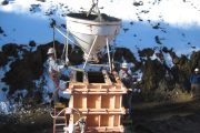 Workers pour concrete into wooden forms at a snowy construction site