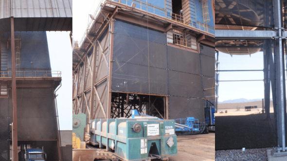 Industrial structures with metal frameworks and large wind fences in a desert setting