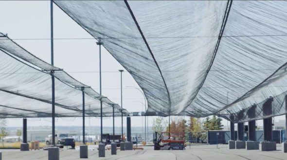 A large open area with a translucent canopy supported by tall poles