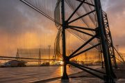 A large industrial wind fence with a sunset in the background